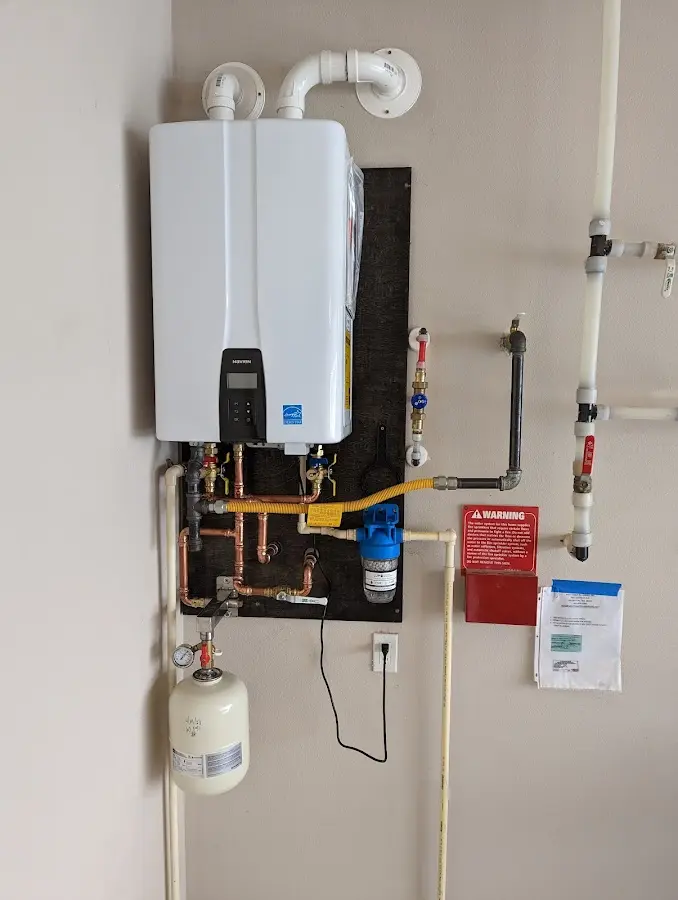 Professional plumber installing copper piping in a Headland home